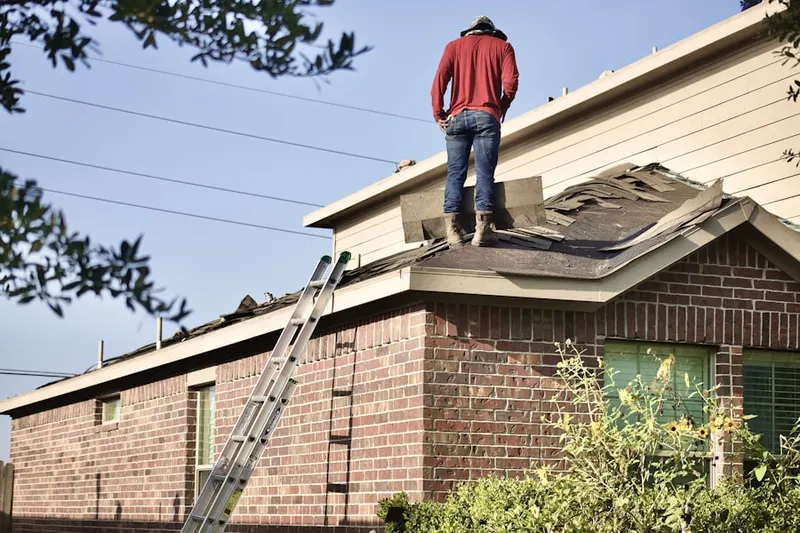 Professional roofer working on a residential roof in Belle Center
